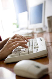 Transcriptionist's Fingers typing on keyboard.